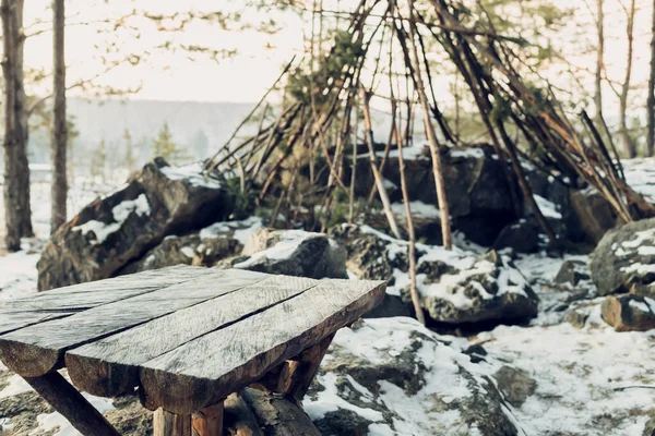 homemade table in the forest for travelers against the background of the hut. homemade table from boards in the forest, free surface for objects