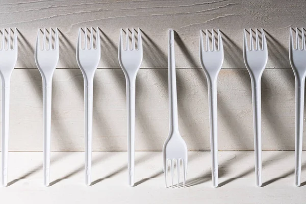 Row Forks Standing Wall One Them Upside Different Others Shadows — Stock Photo, Image