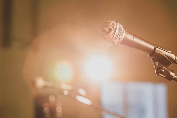 microphone on stage without speakers in the beams of the spotlight, bright light on the stage