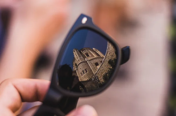 Old stone church reflecting in sunglasses Royalty Free Stock Images