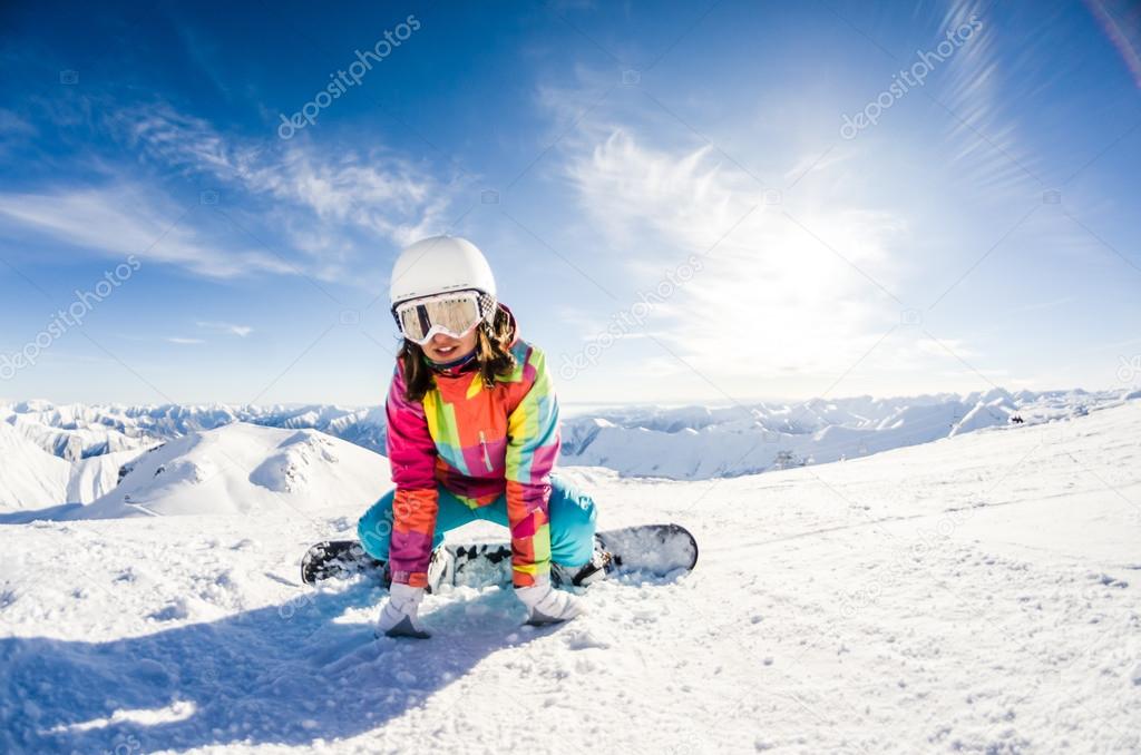 Girl snowboarder taking some rest