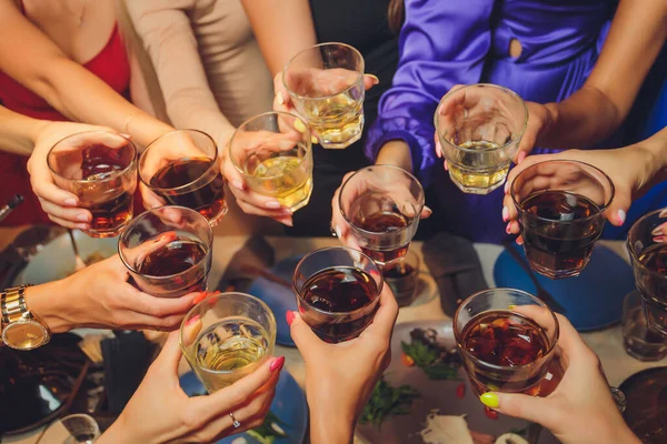 Close up shot of group of people clinking glasses with wine or champagne in front of bokeh background. older people hands. — Stock Photo, Image