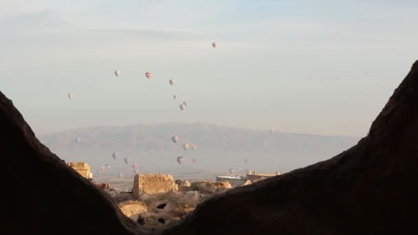 Hot air balloon flying over rock landscape at Cappadocia Turkey. — Stock Video
