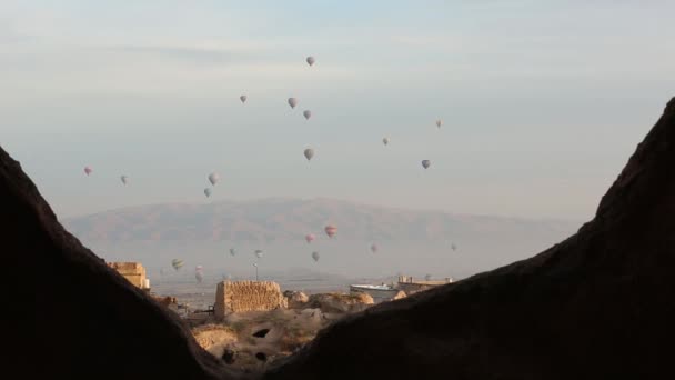 Hot air balloon flying over rock landscape at Cappadocia Turkey. — Stock Video