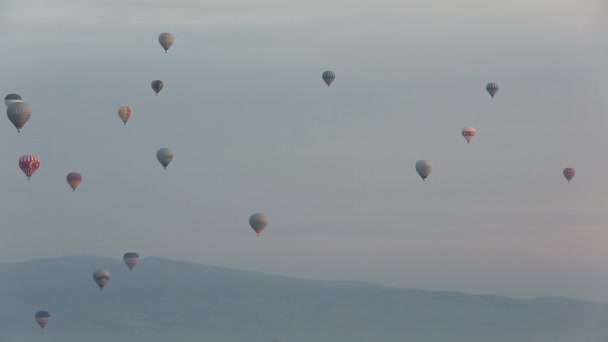 Hot air balloon flying over rock landscape at Cappadocia Turkey. — Stock Video