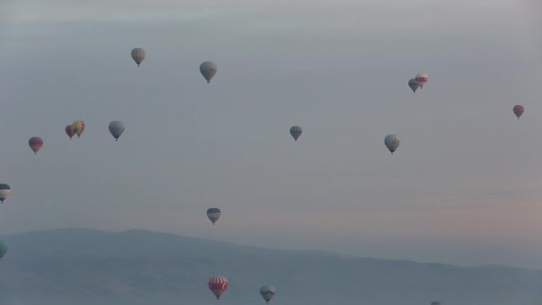 Hot air balloon flying over rock landscape at Cappadocia Turkey. — Stock Video