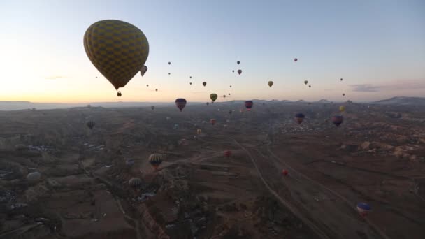 Hot air balloon flying over rock landscape at Cappadocia Turkey. — Stock Video