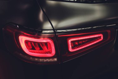 Modern arka ışığı olan siyah bir otomobilin arkasında..