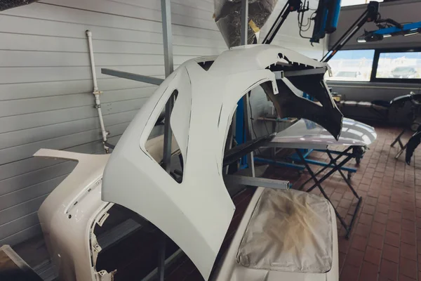 Auto parachoques parte se instala en los bastidores después de pintar en el taller de reparación de automóviles. — Foto de Stock
