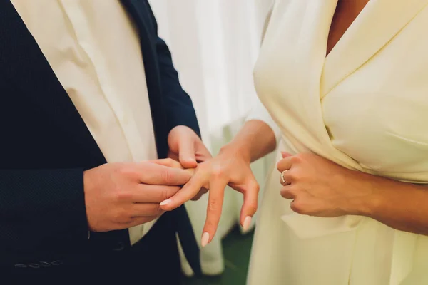 Frischvermählte tauschen Ringe, Bräutigam legt im Standesamt den Ring an die Hand der Braut. — Stockfoto