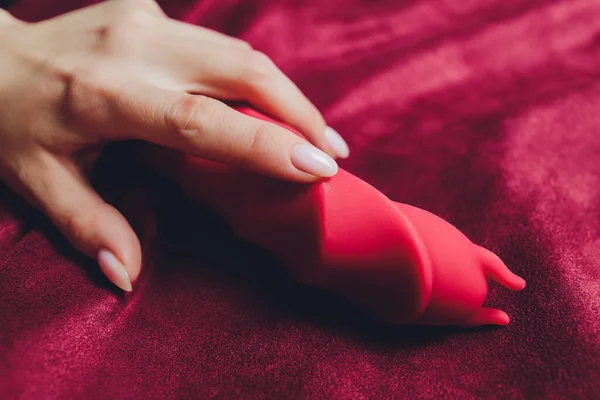 Woman in bedroom holding vibrator in hand. — Stock Photo, Image