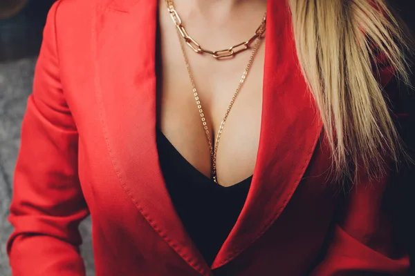 Woman in a red jacket revealing a black bra. — Stock Photo, Image