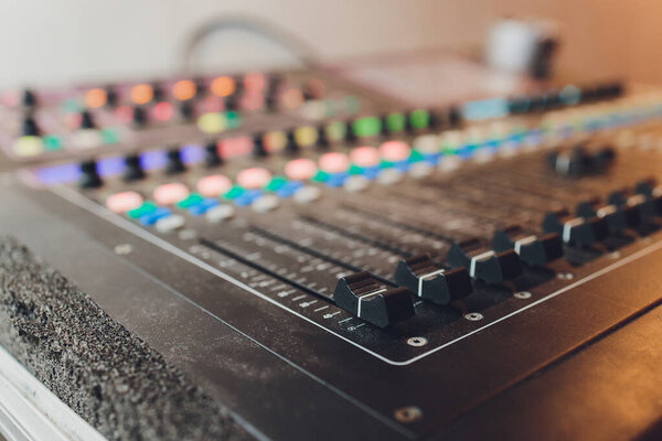 Part of an audio sound mixer with buttons.