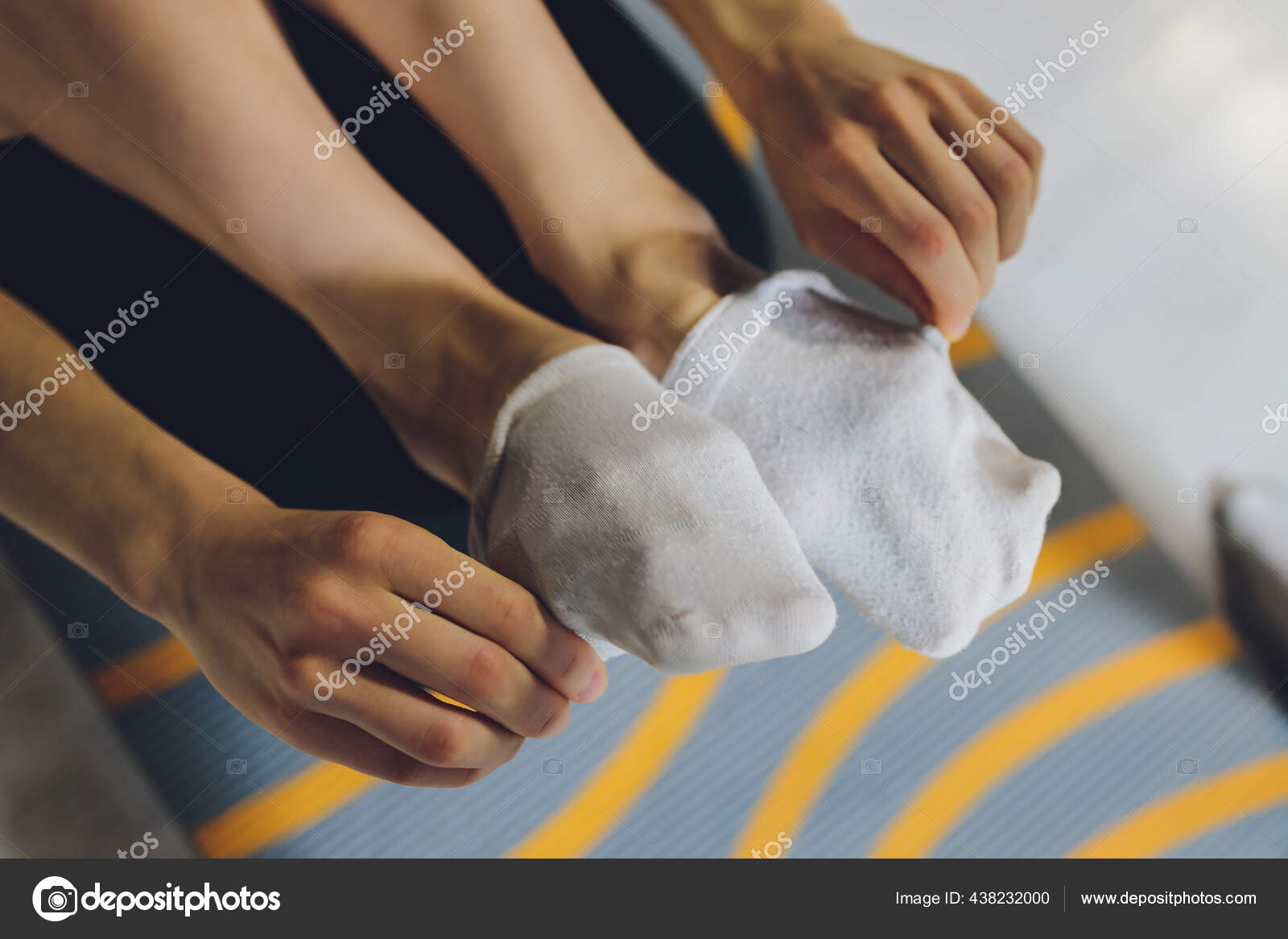 The Guy with Dirty Socks in His Hands on a White Background. Stock