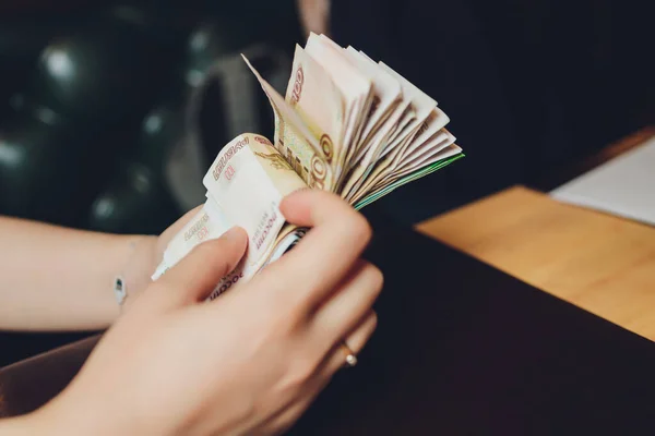 Russian rubles in the hand of a fan.male hand holding many of the Russian banknotes.The transfer of money.The isolated five-thousandth of Russian rubles denominations in a hand.