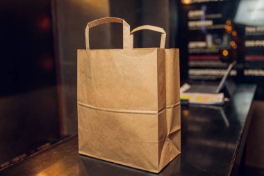 Çağdaş kafe kahve dükkanında, yemek dağıtımında, kafe restoranında, hazır yemek servisinde müşterileri bekleyen tatlı kağıdı torbası..