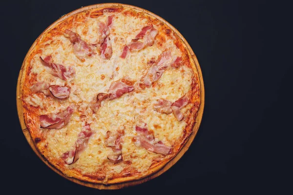 Pizza with sausages on black stone background. — Stock Photo, Image
