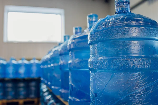 Plastic water bottles on conveyor and water bottling machine industry.