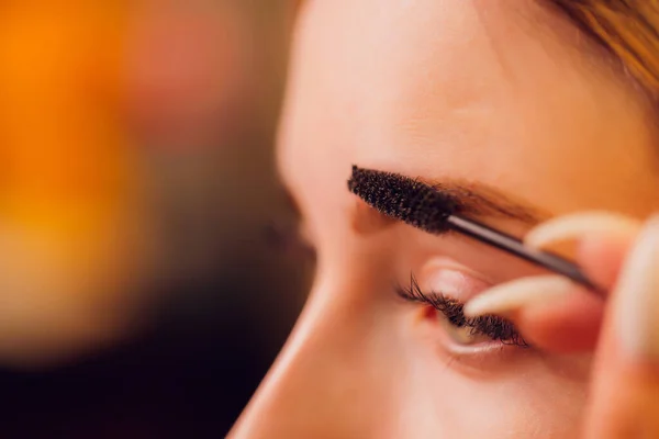 Eyebrows tinting treatment with natural henna dye.