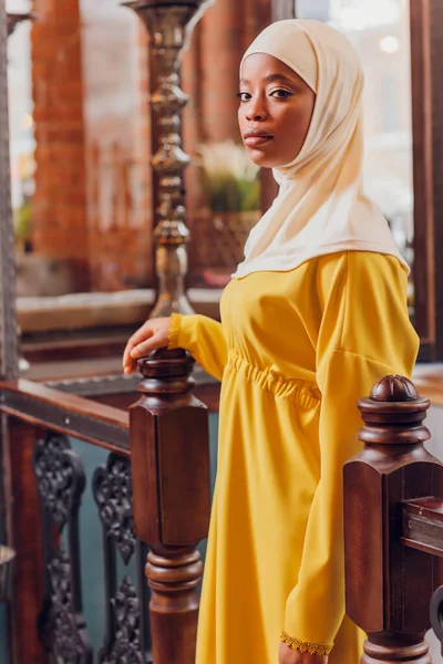 Mooi moslim meisje in hijab glimlachen, wachten op haar eten in een restaurant. — Stockfoto