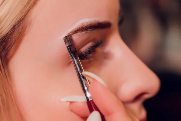 Eyebrows tinting treatment with natural henna dye.