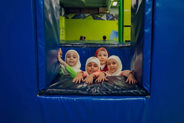 Kinder in muslimischen Kleidern springen auf einem Trampolin. — Stockfoto