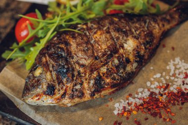 Dorado ızgarada, tahtada, ahşap masada..