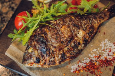 Dorado ızgarada, tahtada, ahşap masada..