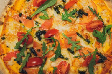 Tahtada roka ve kiraz domatesli pizza..