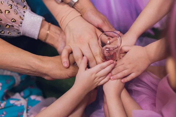 people, cooperation and team work concept - close up of creative team sitting at table and holding hands on top of each, teamwork hand group.