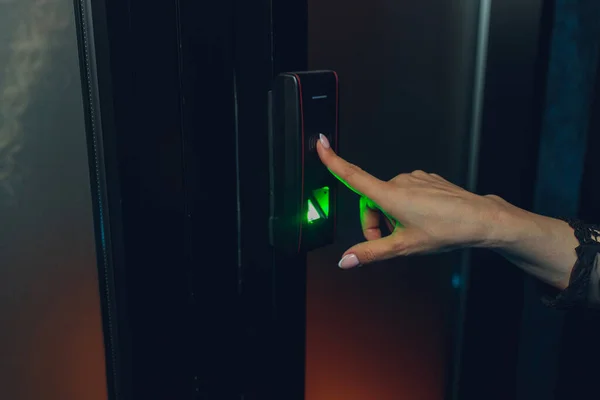 Closeup of a womans finger entering password code on the smart digital touch screen keypad entry door lock in front of the room. Self Check-in, Modern security,Temporary codes.