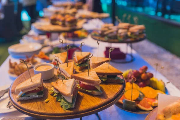 Feche fotos de triângulos de sanduíche variados em uma bandeja de festa de catering. — Fotografia de Stock