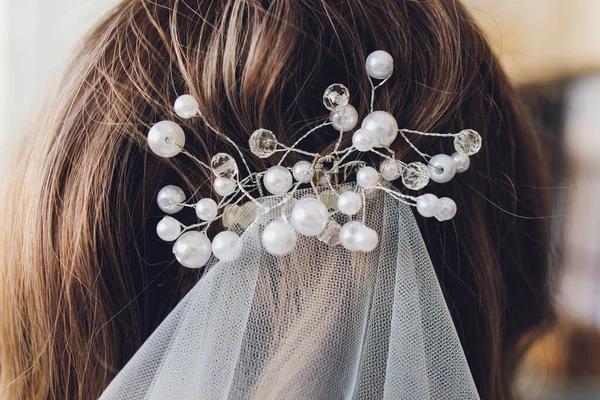 Back view of unrecognizable young woman with red hair in white wedding dress and wreath over blurred outdoors background. — Stock Photo, Image