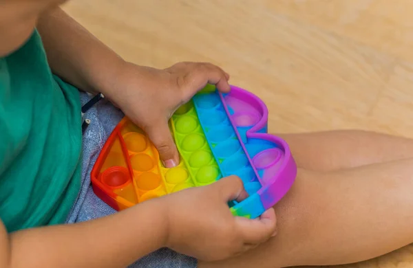 Brinquedo anti-stress pop it fidget baby boy hands. — Fotografia de Stock