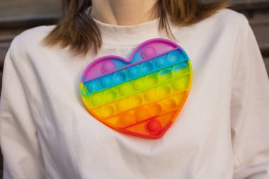 Woman using pop it fidget toy closeup.
