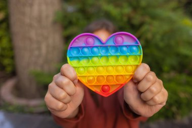 Woman using pop it fidget toy closeup.