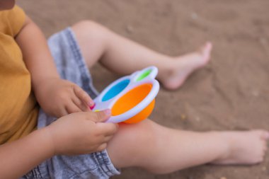 colorful trendy antistress sensory toy fidget push pop it and simple dimple in kids hands, children share toys and playing together.