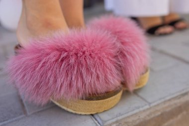 pink slop sandals with thick fur embellishment like pom poms. clipart