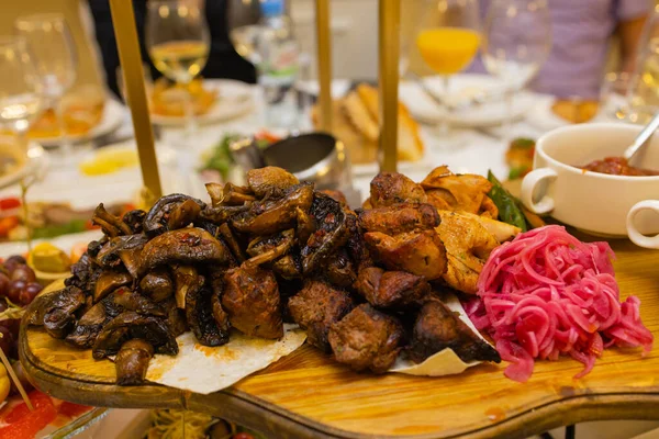 Мясное блюдо жареное на угле со специями на деревянной доске. Стойка баранины, свинины, кебаба, курицы, грибов и томатных соусов для мяса. — стоковое фото