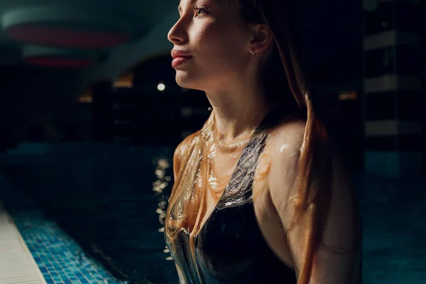 Nő emelkedik úszás víz alatt a medencében. — Stock Fotó