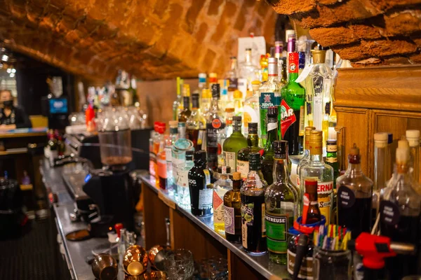 Ufa, Russia, 1 July, 2021: Several types of bottled alcohol are displayed on some shelves in a pub. Stock Photo