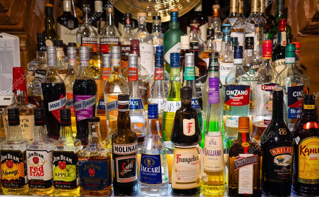 Ufa, Russia, 1 July, 2021: Several types of bottled alcohol are displayed on some shelves in a pub