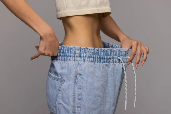 Woman showing how much weight she lost. — Stock Photo, Image