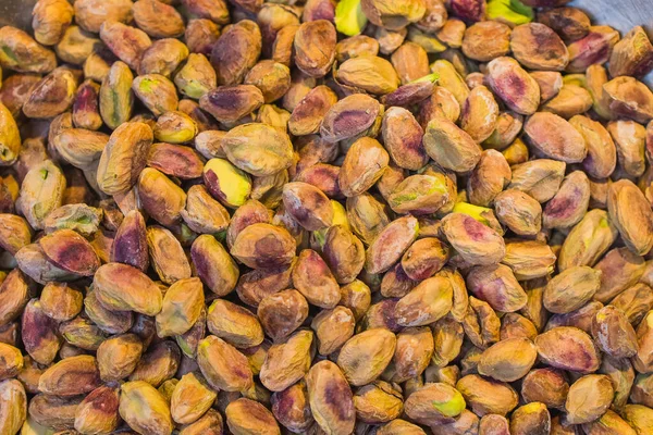 Background made of mixed nuts. Healthy snack and food. Salted and spicy pistachios, cashew and almond. Top view. Assorted nuts. — Stock Photo, Image