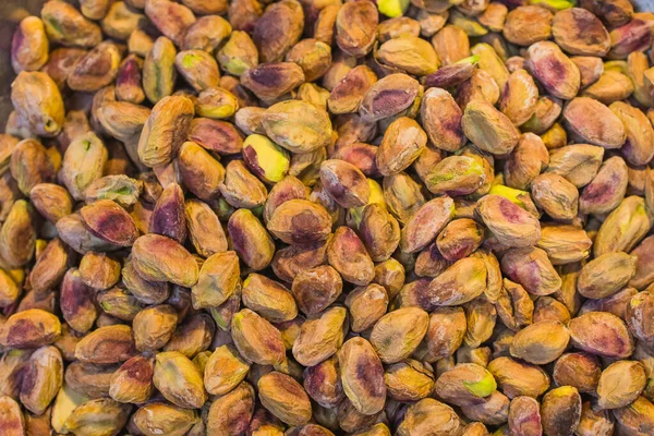 Background made of mixed nuts. Healthy snack and food. Salted and spicy pistachios, cashew and almond. Top view. Assorted nuts. — Stock Photo, Image