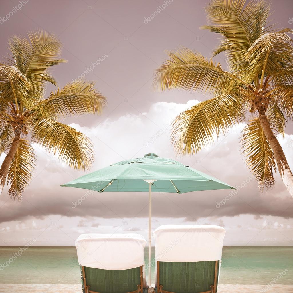 Beach umbrella and palm trees