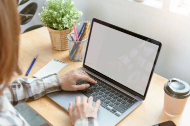 Businessman hands using laptop with blank screen. Mock-up of computer monitor. Copyspace ready for design or text.	
