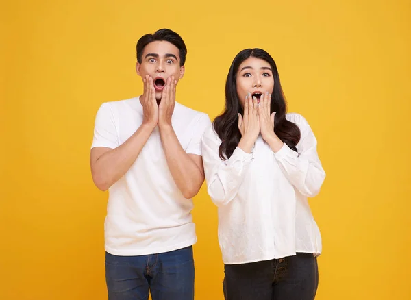 Surprise Young Asian Couple Man Woman Happy Amazed Yellow Background — Zdjęcie stockowe