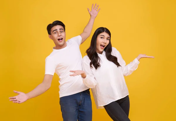 Surprise Young Asian Couple Man Woman Happy Amazed Yellow Background — стоковое фото