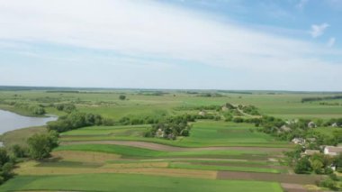Countryside aerial view with farms, fields and pastures in summer